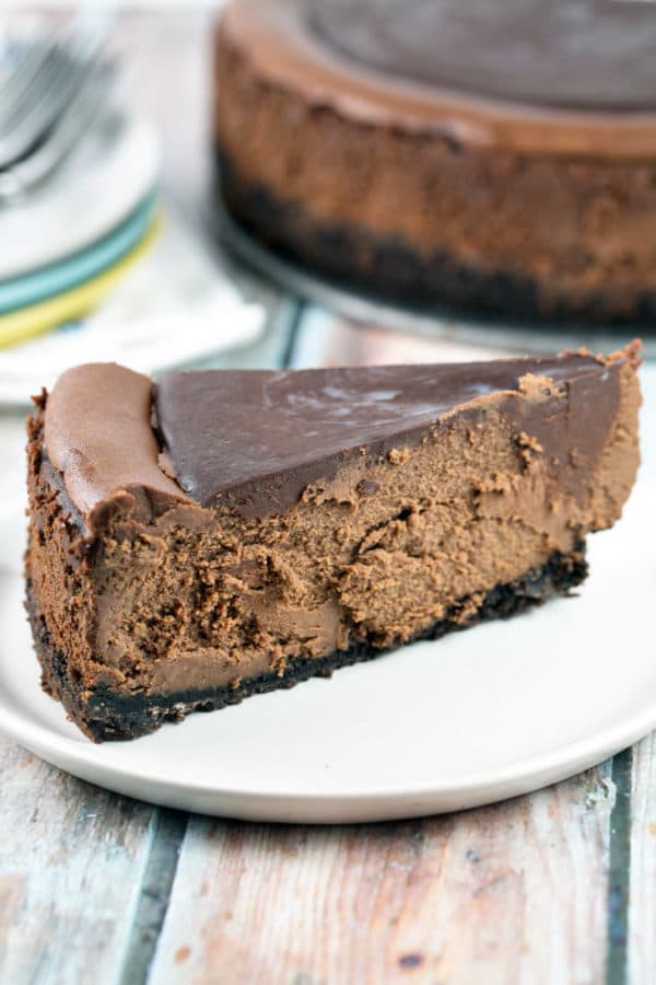 Rich, decadent deep chocolate cheesecake covered in rich chocolate ganache. No water bath necessary! {Bunsen Burner Bakery}