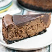 Rich, decadent deep chocolate cheesecake covered in rich chocolate ganache. No water bath necessary! {Bunsen Burner Bakery}