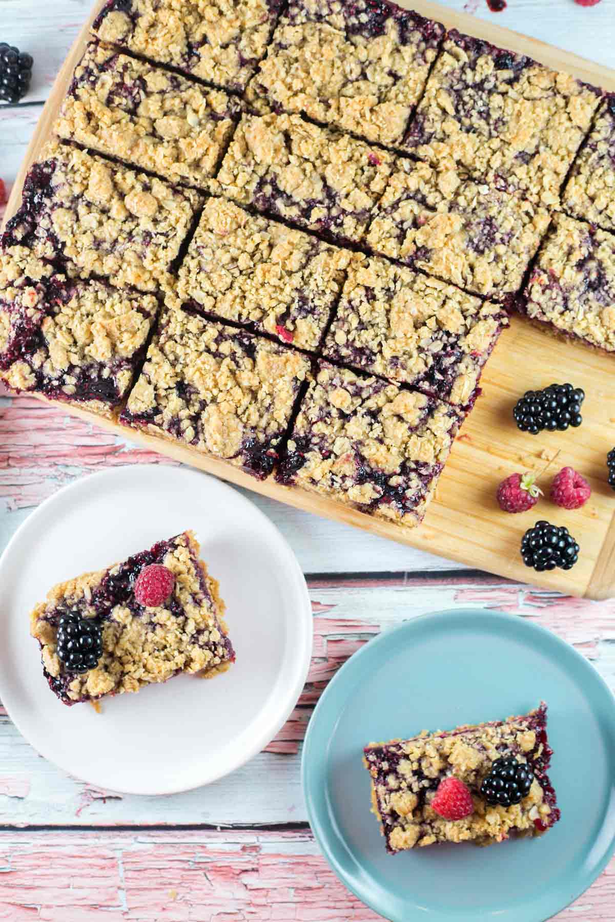 overhead view of sliced dessert bars made with fresh berries and an oatmeal crumb topping