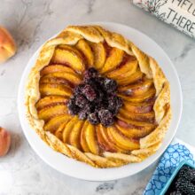 blackberry peach galette on a cake plate