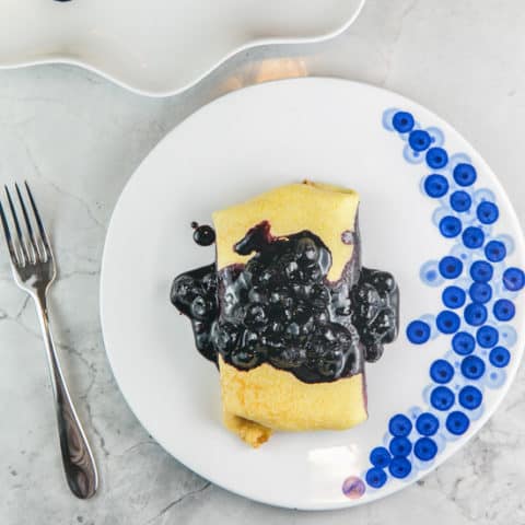 Blueberry Blintzes: Thin flour pancakes filled with creamy ricotta and a homemade blueberry sauce, these baked blueberry blintzes are an all-time brunch favorite! Plus all the tips you need to make them ahead of time. #bunsenburnerbakery #blintzes #brunch #breakfast