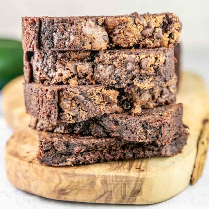slices of chocolate zucchini bread with chocolate chip streusel stacked on top of each other.