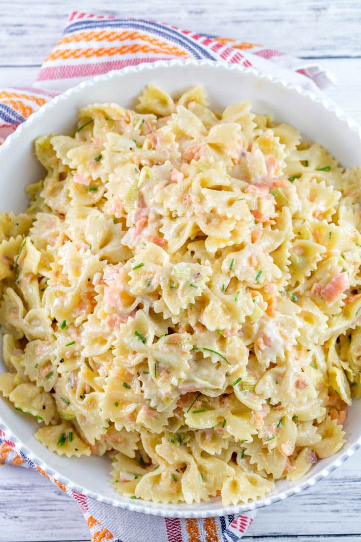 large white serving bowl filled with creamy smoked salmon pasta.