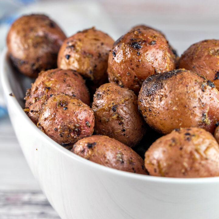 serving bowl filled with small grilled potatoes