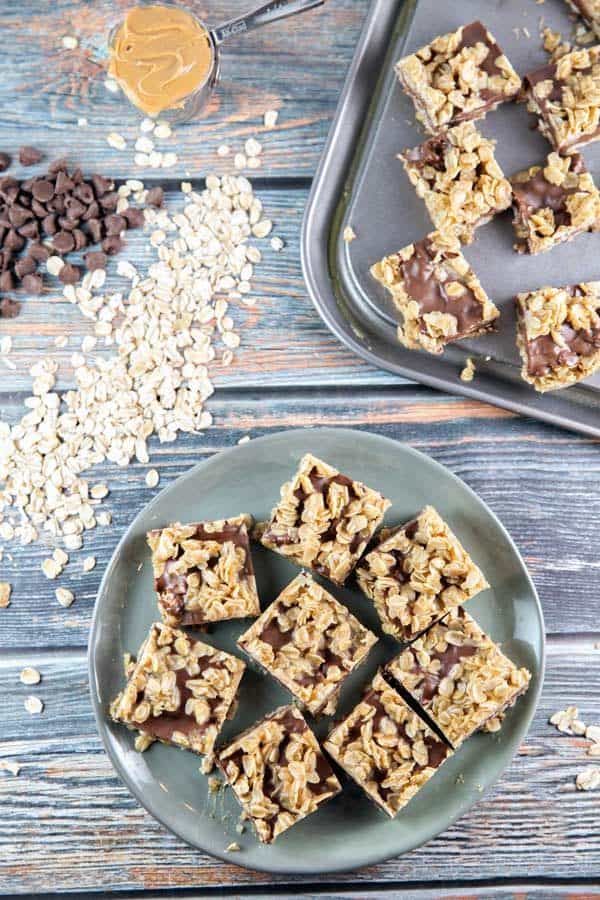 no bake peanut butter bars cut into squares surrounded by chocolate chips and oats