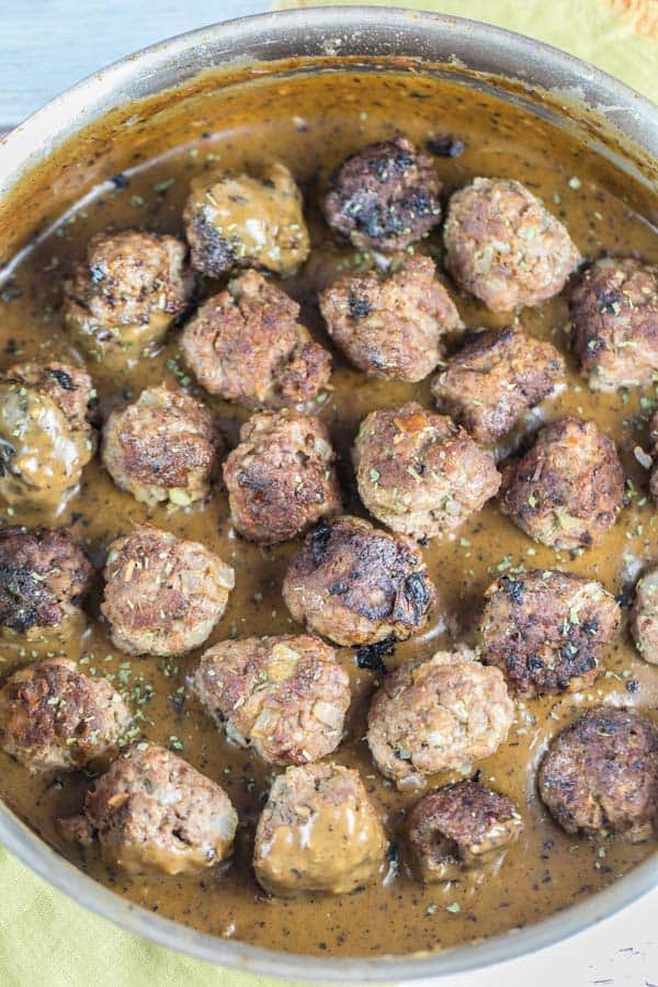 Swedish Meatballs: The ultimate comfort food. Homemade meatballs with thick gravy and lingonberry jam, served over egg noodles or mashed potatoes. {Bunsen Burner Bakery} #swedishmeatballs #dinner #meatballs