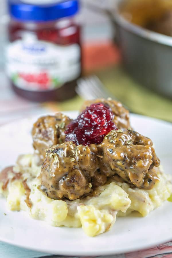 Swedish Meatballs: The ultimate comfort food. Homemade meatballs with thick gravy and lingonberry jam, served over egg noodles or mashed potatoes. {Bunsen Burner Bakery} #swedishmeatballs #dinner #meatballs