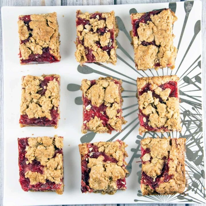 9 strawberry rhubarb oatmeal bars on a decorative square plate