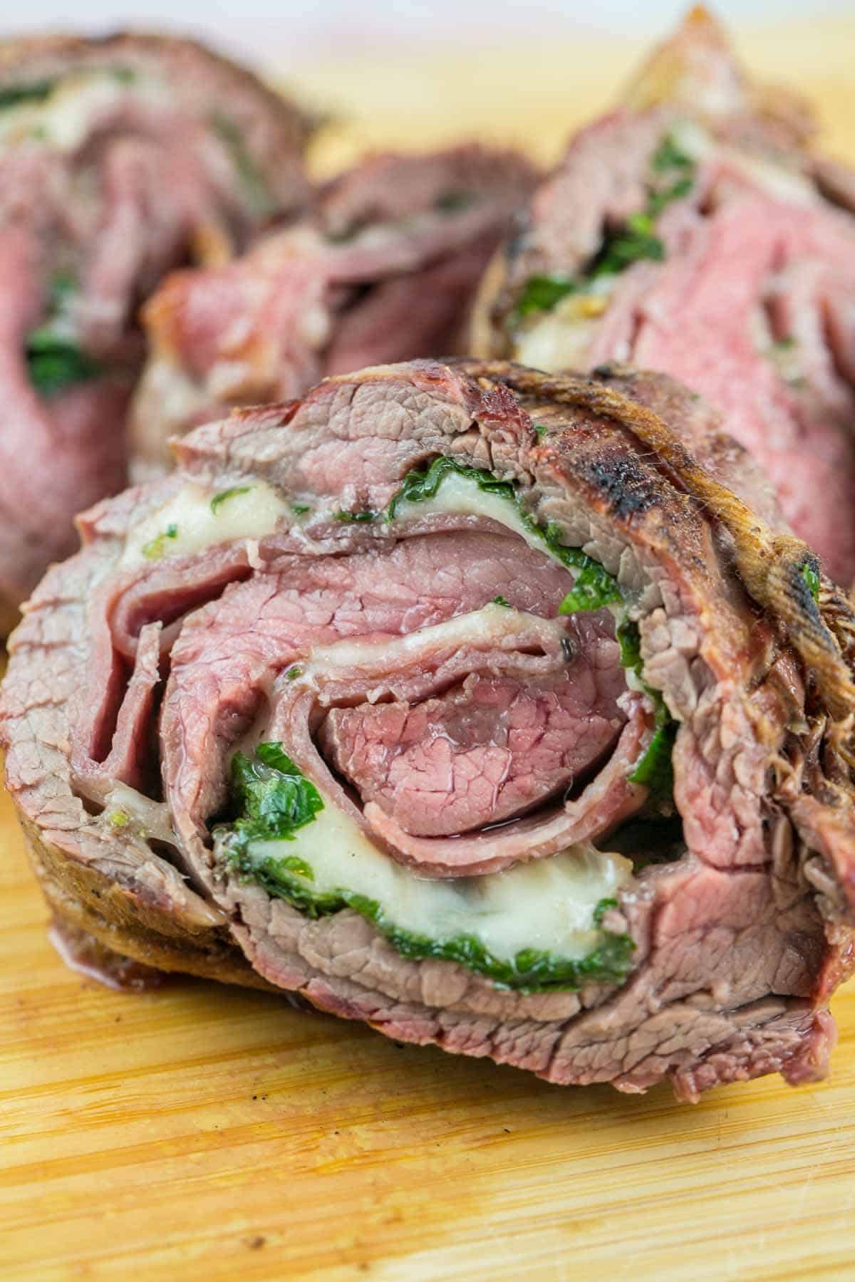 Italian Flank Steak Pinwheels: flank steak stuffed with salami and provolone, rolled tightly, and grilled. Go ahead, impress your friends - they don't have to know how easy this is. {Bunsen Burner Bakery} #flanksteak #steakpinwheels #grilling #dinner