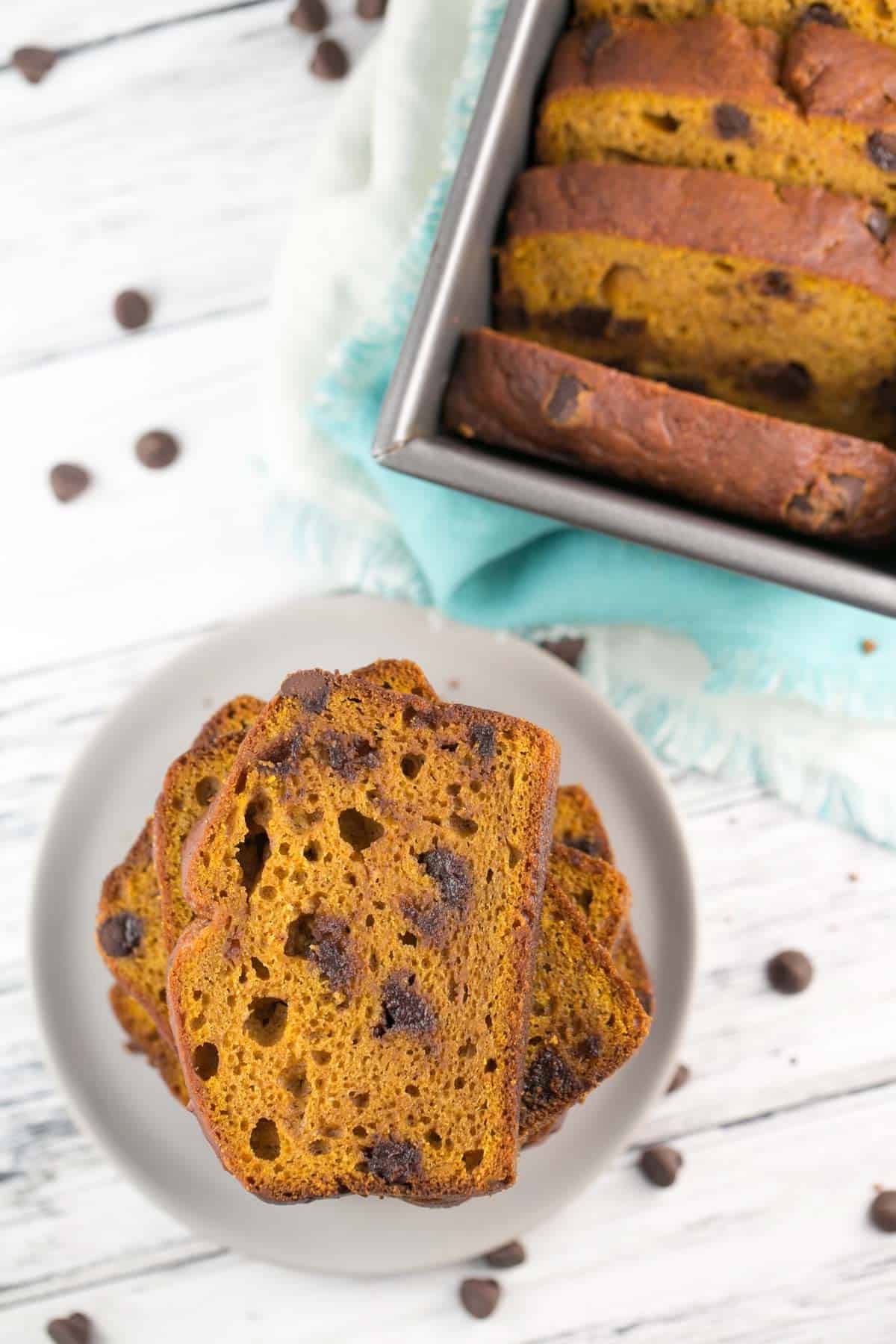 several slices of chocolate chip pumpkin bread on a grey plate.