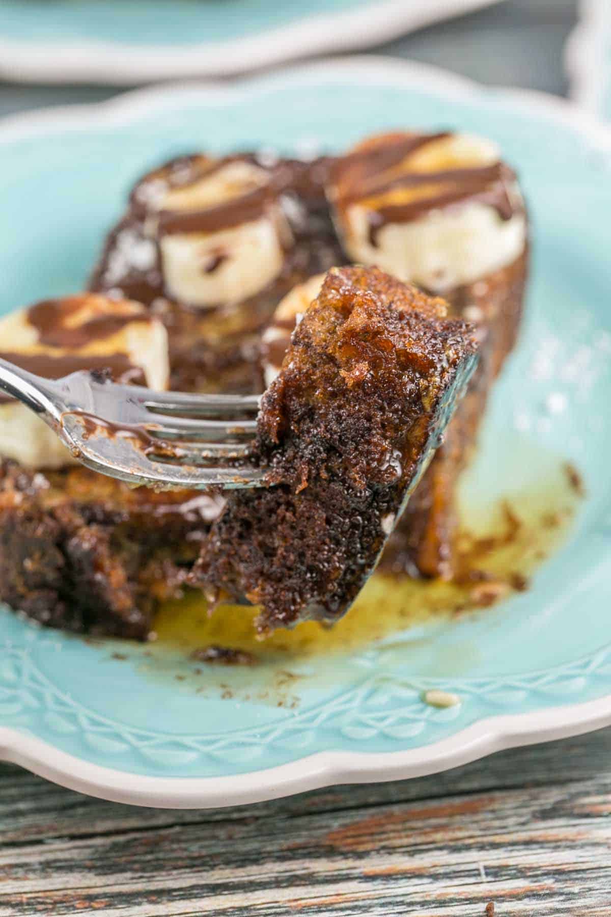 one bite of banana bread french toast on a fork.