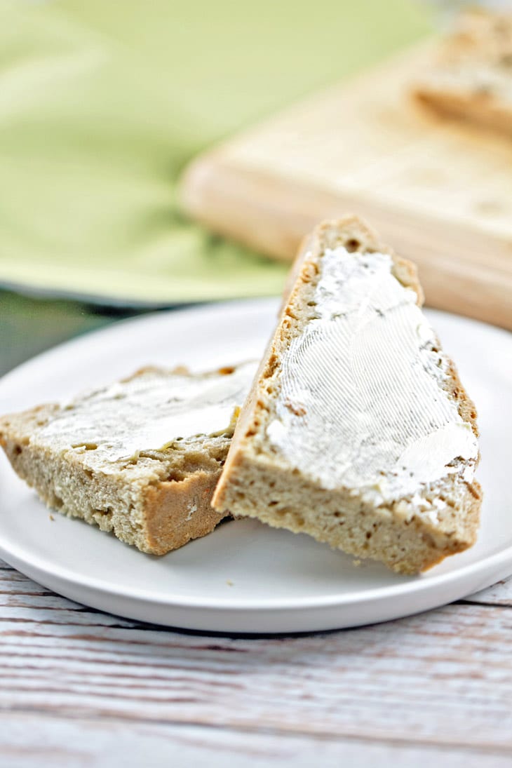 slice of soda bread cut in half and slathered with butter