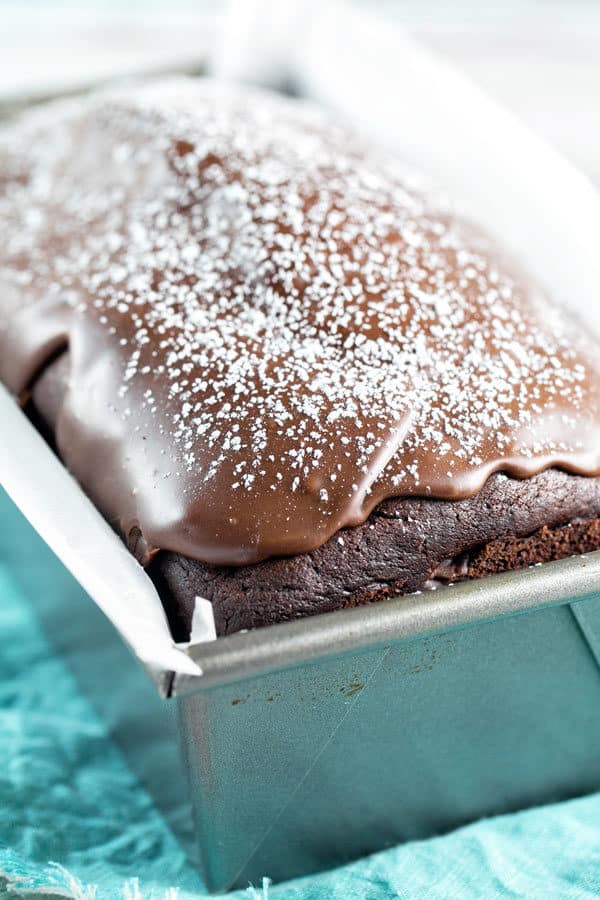 side view of a chocolate buttermilk quick bread showing a thick layer of chocolate glaze