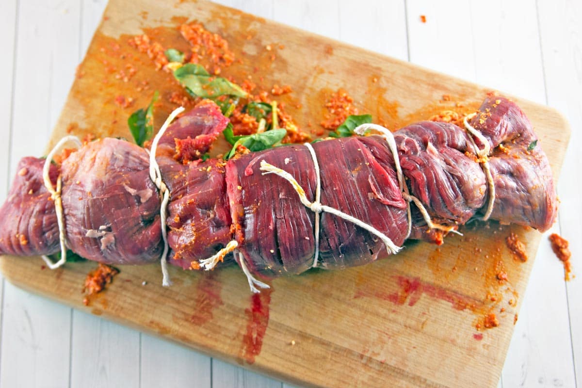 Roasted Red Pepper Stuffed Flank Steak: Stuck in a grilling rut? Shake things up with the bold, bright flavors of a Mediterranean-inspired stuffed flank steak, starring roasted red pepper pesto, feta, and spinach. #ad https://ooh.li/21ca3ca