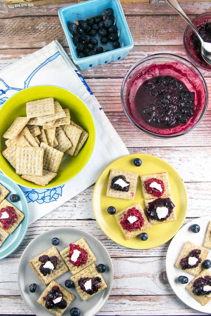 TriBerryTriscuits (Triple Berry Herb Cracker Bites): The perfect summer entertaining appetizer bites -- easy homemade berry compote paired with fresh herbs, TRISCUIT crackers, and a dollop of honey goat cheese. {Bunsen Burner Bakery}