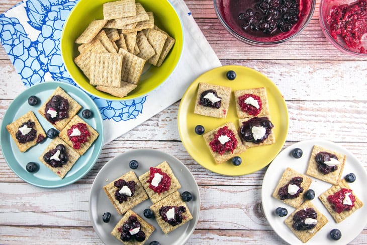 TriBerryTriscuits (Triple Berry Herb Cracker Bites): The perfect summer entertaining appetizer bites -- easy homemade berry compote paired with fresh herbs, TRISCUIT crackers, and a dollop of honey goat cheese. {Bunsen Burner Bakery}