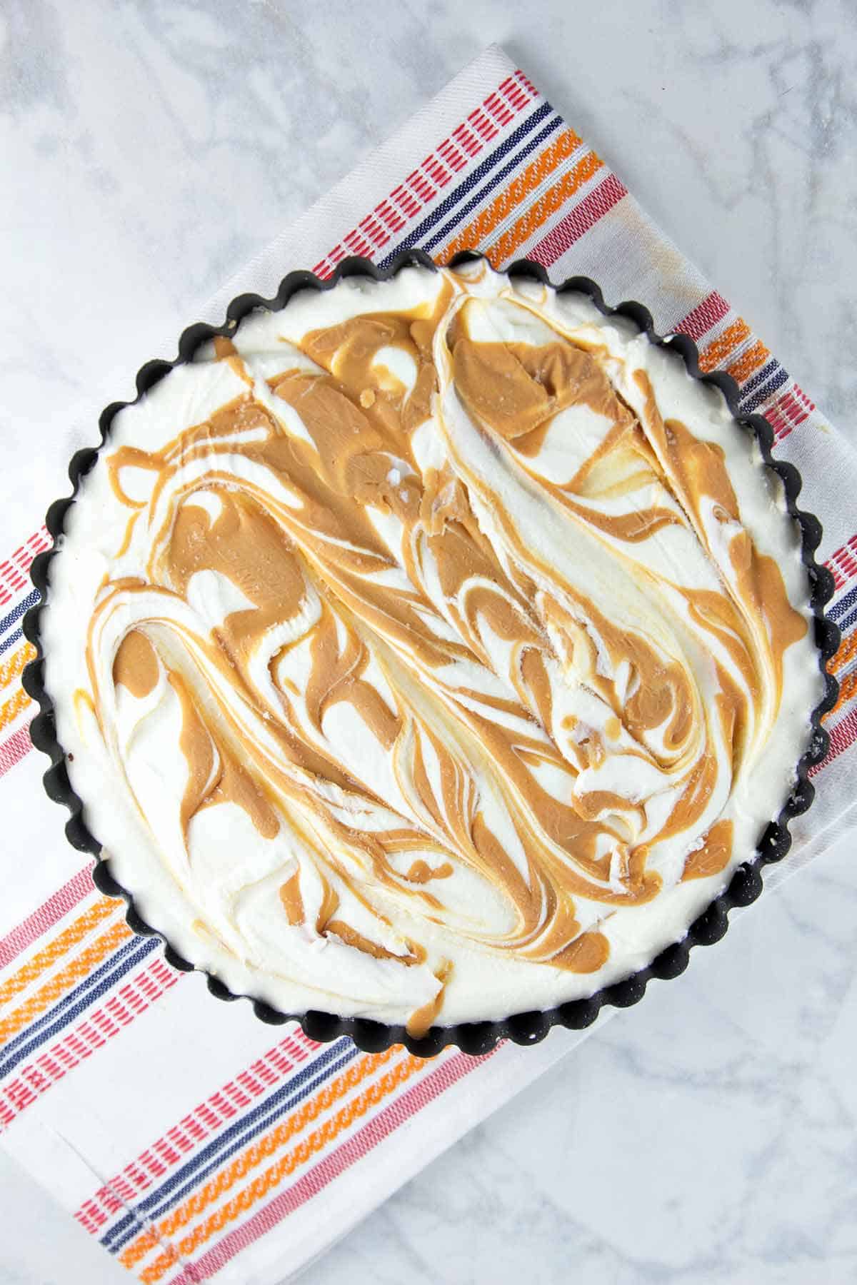 Brownie Bottom Peanut Butter Ice Cream Pie: Why choose between brownies and ice cream when you can make one show-stopping dessert with both? Grab a fork (or spoon) and dig on in! #bunsenburnerbakery #icecream #brownies #icecreampie #icecreamcake