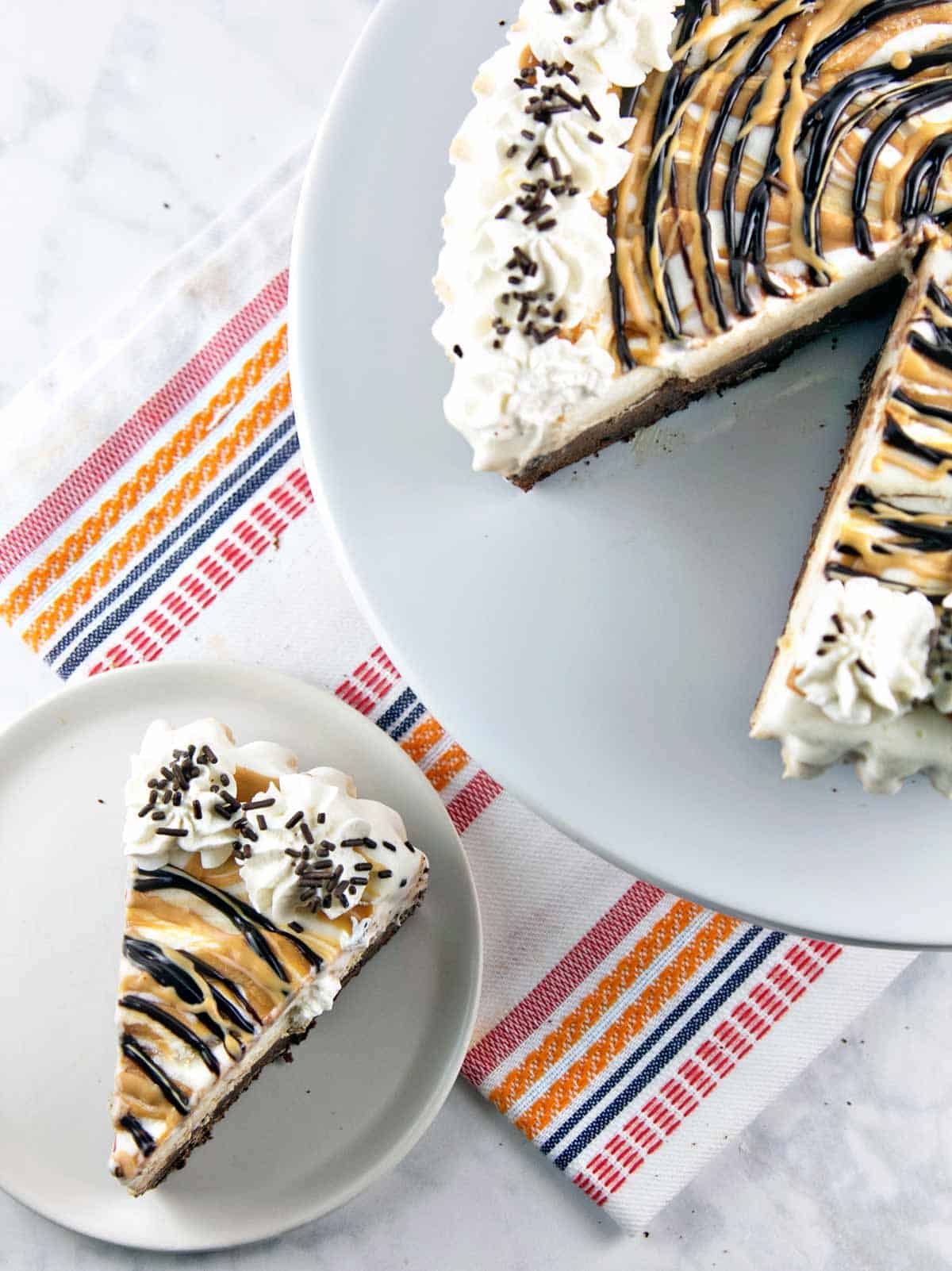 Brownie Bottom Peanut Butter Ice Cream Pie: Why choose between brownies and ice cream when you can make one show-stopping dessert with both? Grab a fork (or spoon) and dig on in! #bunsenburnerbakery #icecream #brownies #icecreampie #icecreamcake