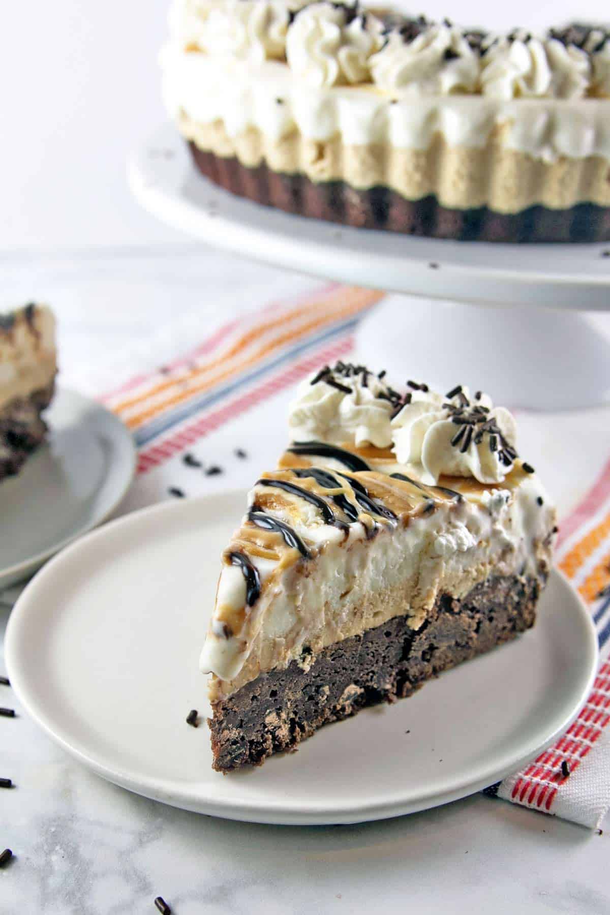 Brownie Bottom Peanut Butter Ice Cream Pie: Why choose between brownies and ice cream when you can make one show-stopping dessert with both? Grab a fork (or spoon) and dig on in! #bunsenburnerbakery #icecream #brownies #icecreampie #icecreamcake