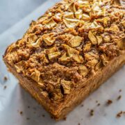 loaf of apple bread covered with cinnamon crumble and chopped apples