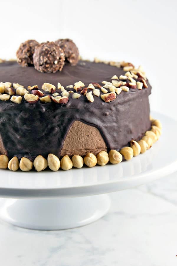 Chocolate Hazelnut Cake: two layers of rich chocolate cake, sandwiched between layers of fluffy Nutella buttercream, topped with chocolate ganache and chopped hazelnuts.  {Bunsen Burner Bakery}