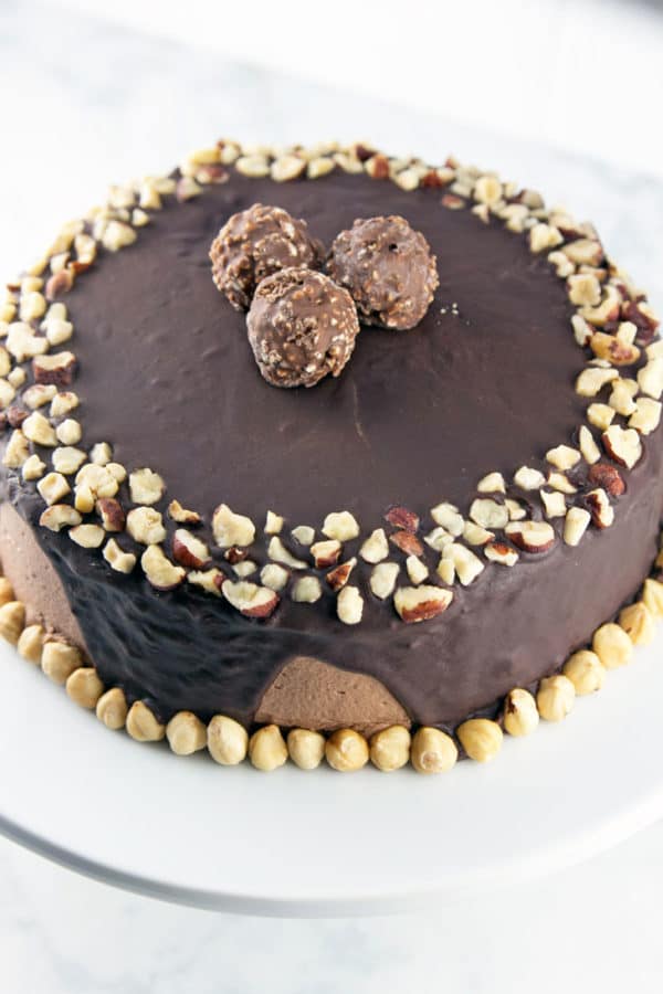 Chocolate Hazelnut Cake: two layers of rich chocolate cake, sandwiched between layers of fluffy Nutella buttercream, topped with chocolate ganache and chopped hazelnuts.  {Bunsen Burner Bakery}