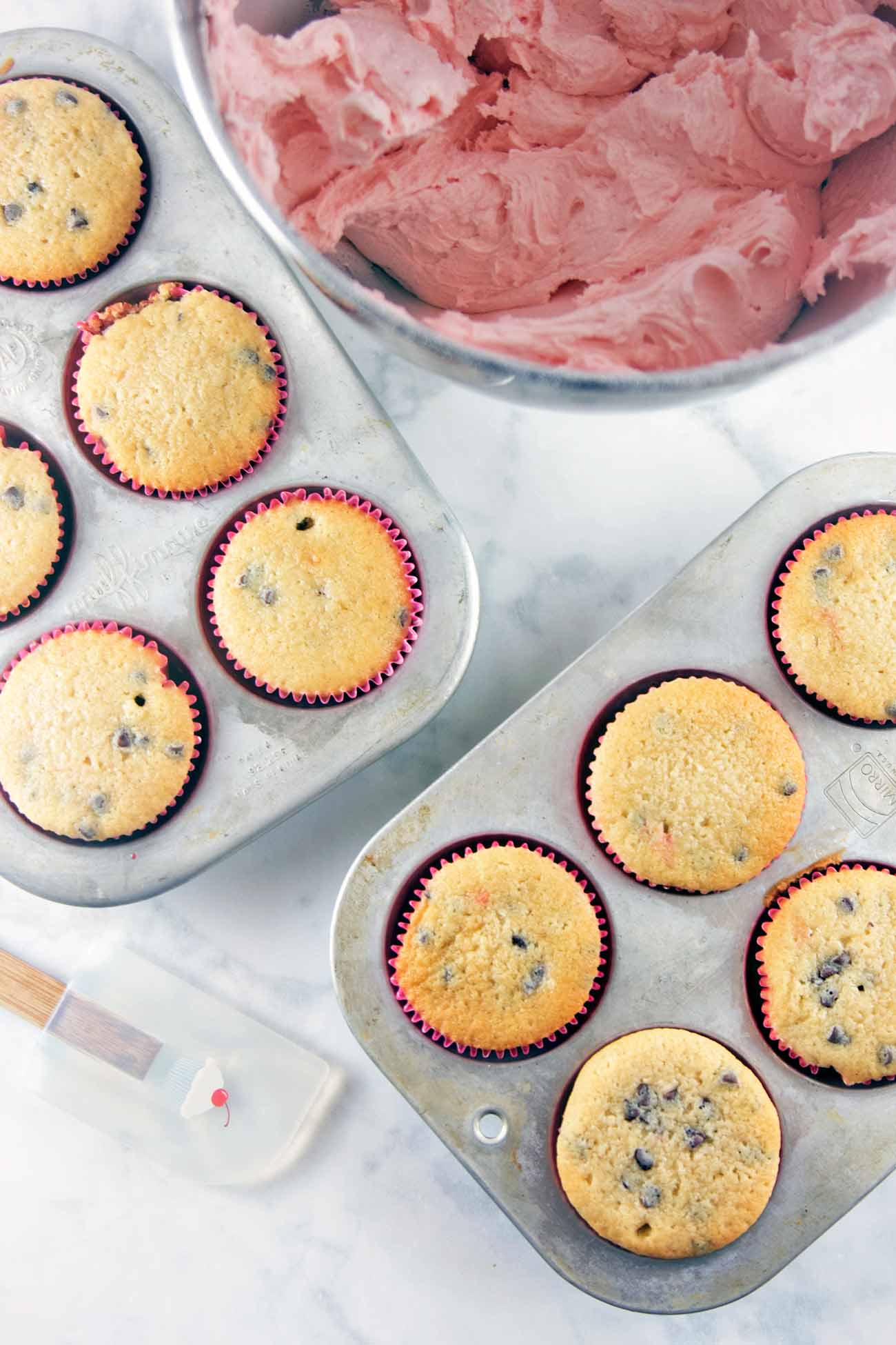 Chocolate Chip Cherry Cupcakes: vanilla-speckled cupcakes studded with mini chocolate chips and a pile of fluffy cherry buttercream. Top with a cherry - or bake one right inside! {Bunsen Burner Bakery}