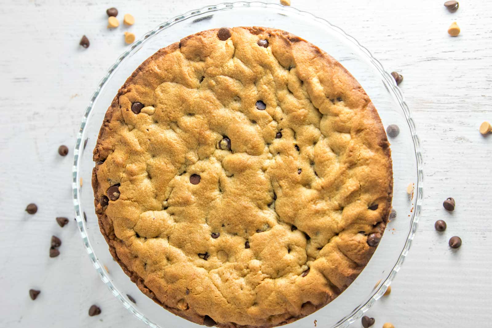 Peanut Butter Cup Cookie Cake: a peanut butter chocolate chip cookie cake, topped with whipped peanut butter ganache, chopped peanut butter cups, and chocolate and peanut butter sauces.  {Bunsen Burner Bakery}