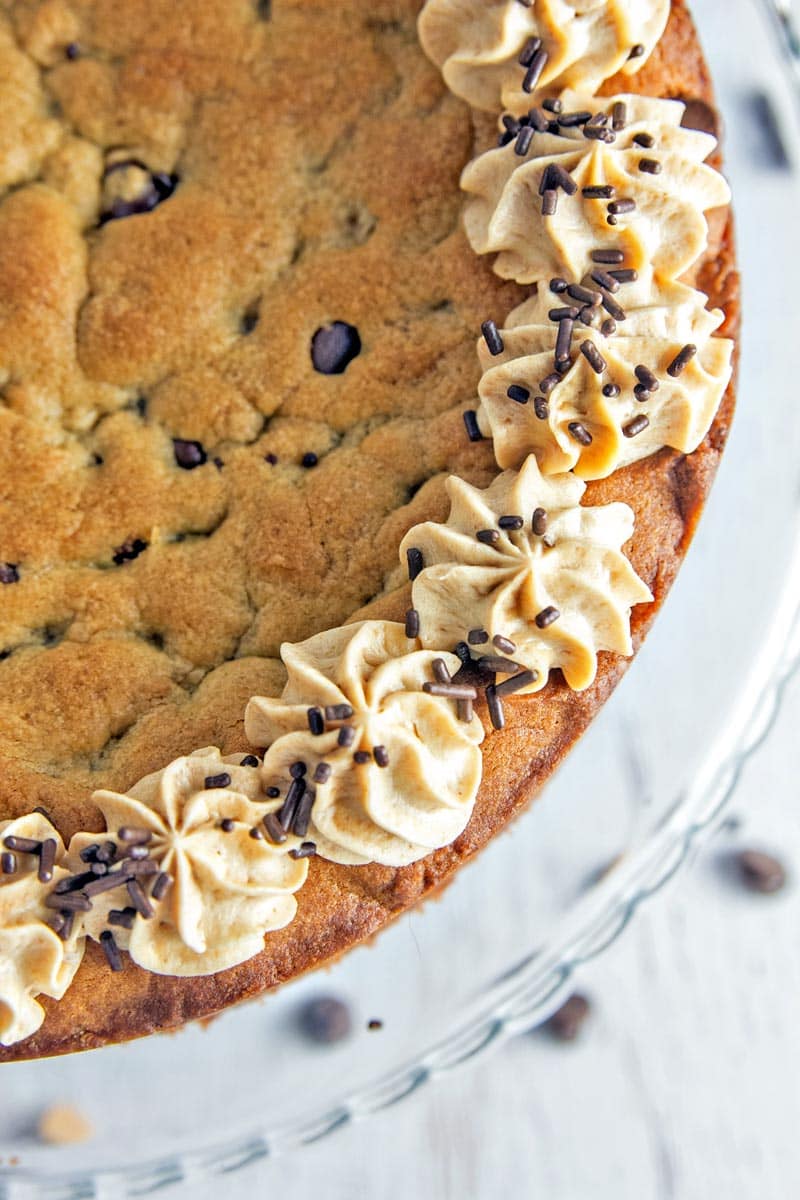 Peanut Butter Cup Cookie Cake: a peanut butter chocolate chip cookie cake, topped with whipped peanut butter ganache, chopped peanut butter cups, and chocolate and peanut butter sauces.  {Bunsen Burner Bakery}