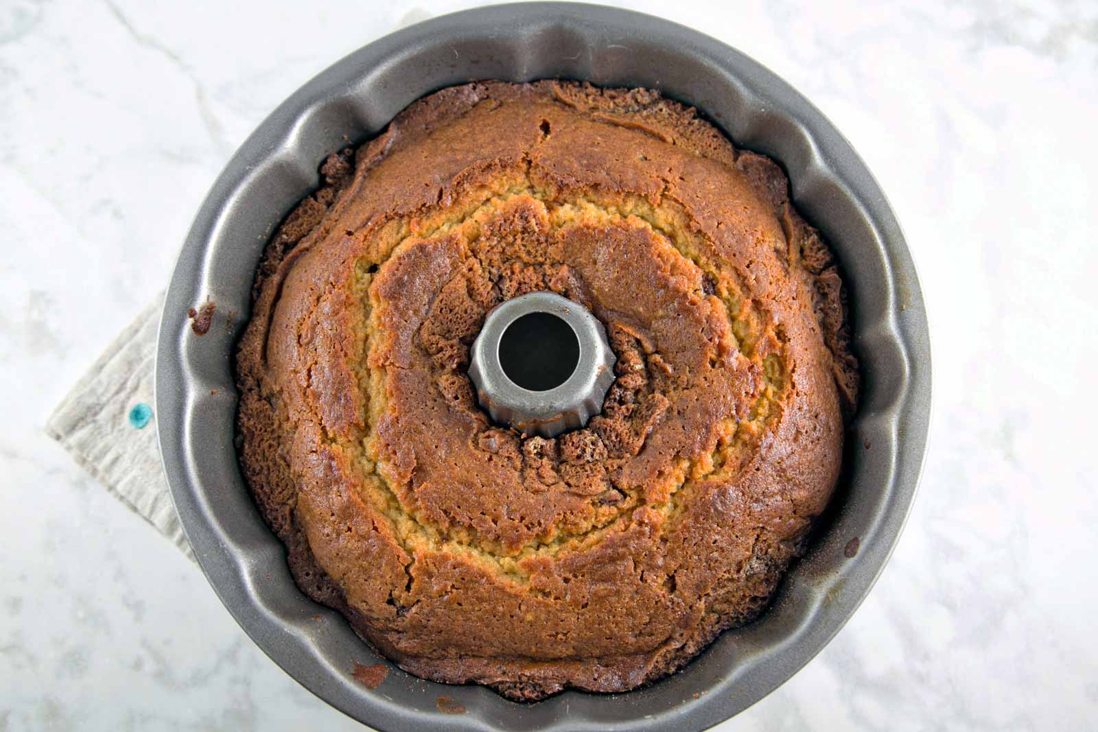 Cinnamon Swirl Bundt Cake: one bowl, whisk by hand, with cinnamon cream cheese frosting. Plus tips for the BEST cake from a boxed cake mix! {Bunsen Burner Bakery}