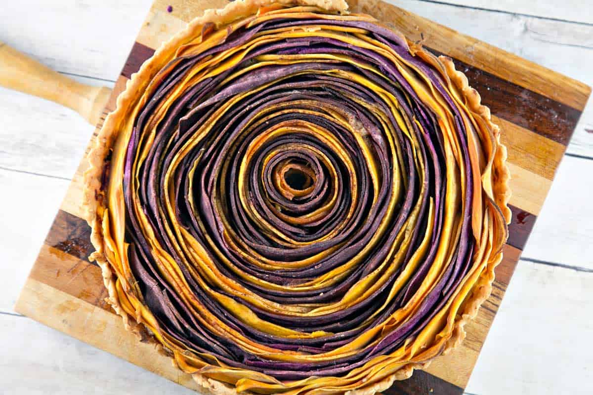 overhead view of a spiral sweet potato tart with concentric orange and purple circles.