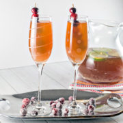 two champagne glasses filled with cranberry cider punch