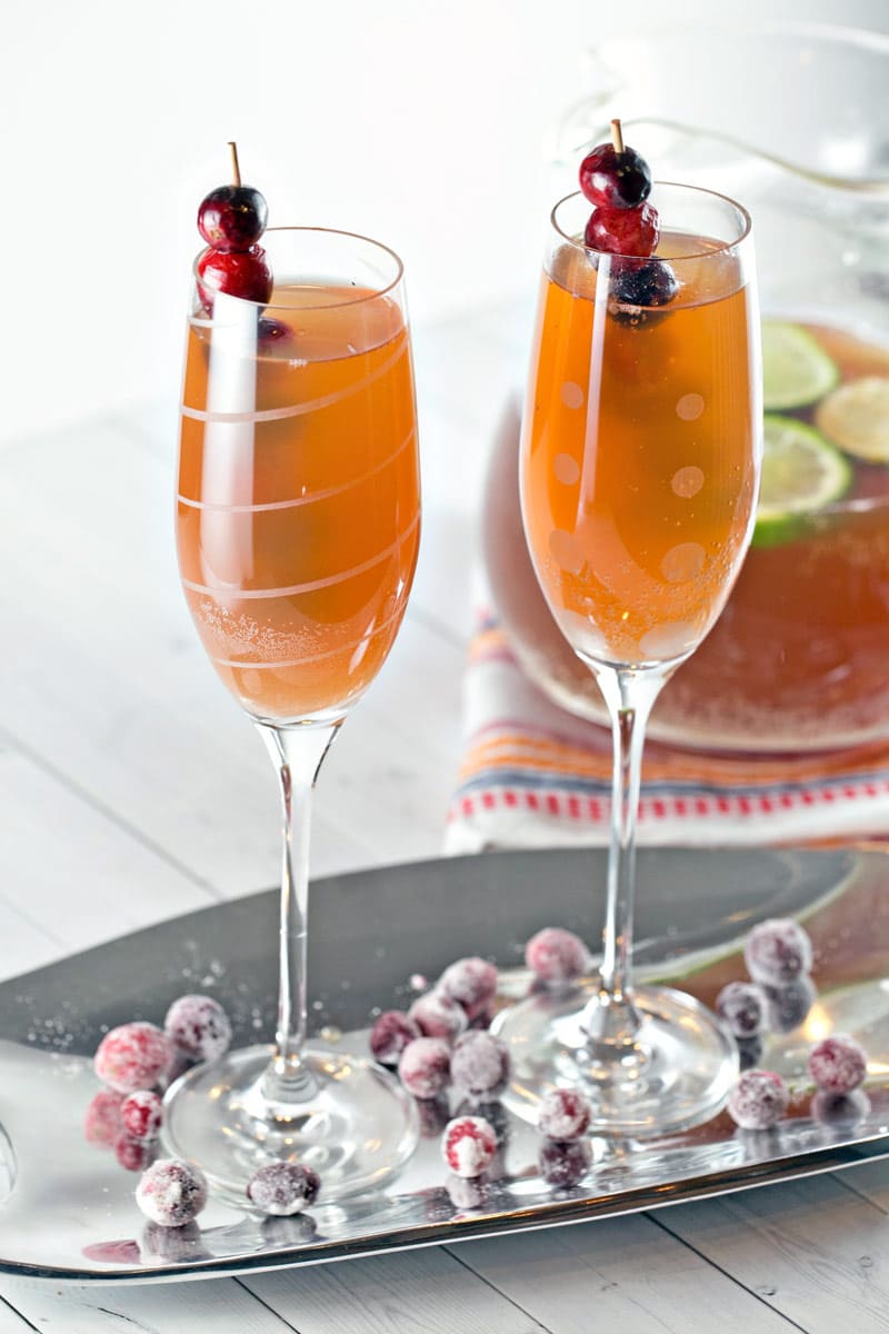 two champagne flutes filled with an apple cider bourbon punch.