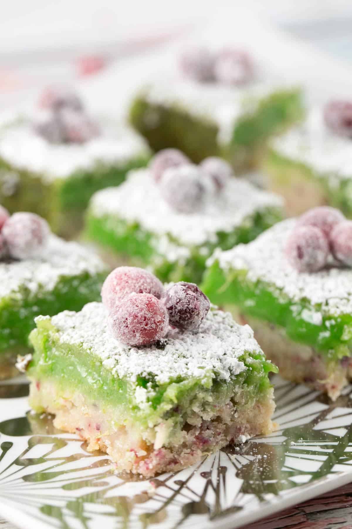 side view of cranberry lime bars showing the lime custard and shortbread crust.