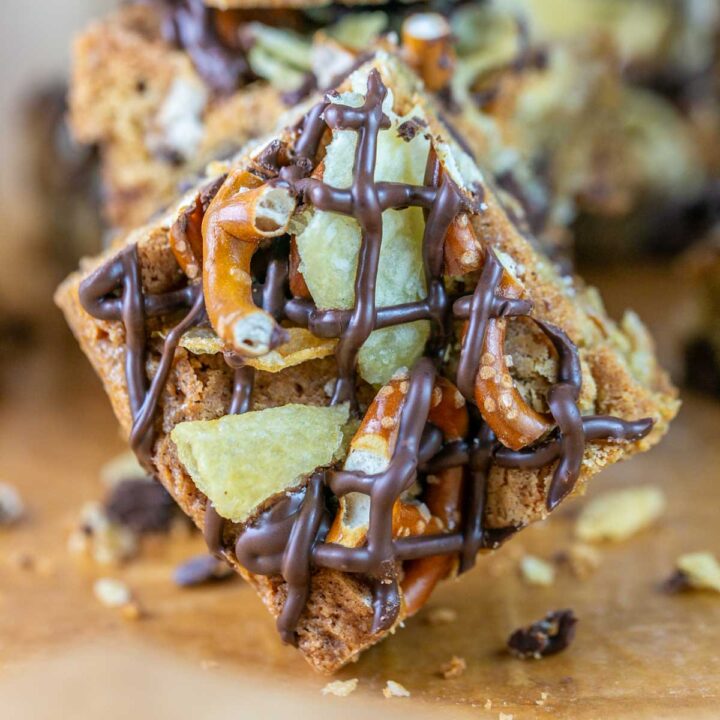 chocolate chip cookie bar covered with chocolate drizzle, pretzels, and potato chips.