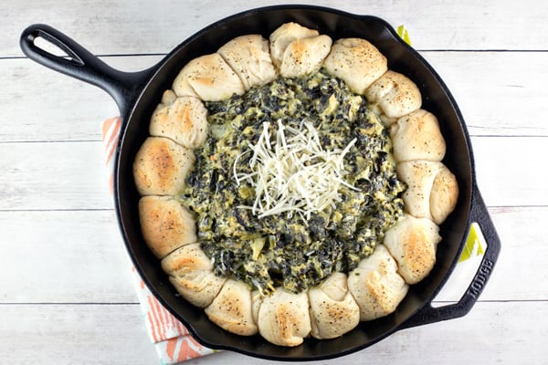 Up your spinach and artichoke dip game with this spinach and artichoke biscuit skillet - flaky biscuits surrounding bubbling hot dip! #bunsenburnerbakery #appetizers #dip #superbowl #partyfood