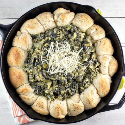 Up your spinach and artichoke dip game with this spinach and artichoke biscuit skillet - flaky biscuits surrounding bubbling hot dip! #bunsenburnerbakery #appetizers #dip #superbowl #partyfood