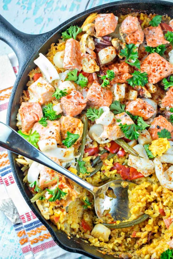 One Pan Salmon Paella: Tired of boring salmon? Try something new and different with one pan salmon paella. Made with easy-to-find ingredients, this is a delicious, heart-healthy dinner choice. {Bunsen Burner Bakery}