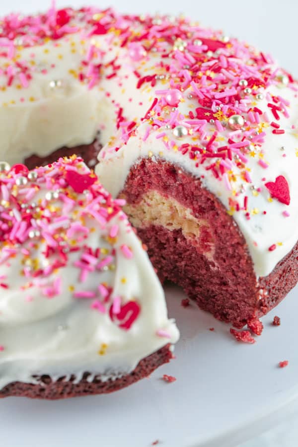view of the inside of a red velvet bundt cake showing the cream cheese swirl in the center