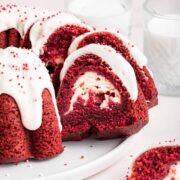 side view of a slice of red velvet bundt cake with a cream cheese swirl in the middle.