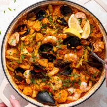 easy homemade paella made with salmon in a cast iron pan.