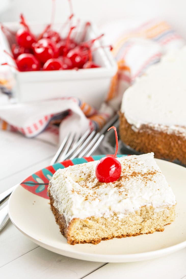 Tres Leches Cake: a simple vanilla sponge cake soaked in a sweet three-milk glaze and covered with fresh whipped cream. It's the perfect end to a spicy Mexican feast or your Cinco de Mayo celebrations! {Bunsen Burner Bakery}