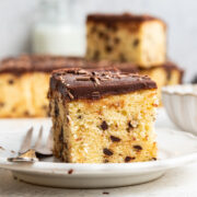 slices of chocolate chip pound cake with hot fudge frosting on a dessert plate.