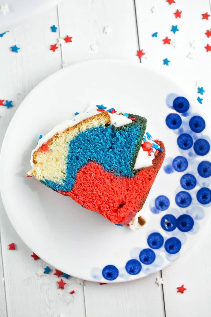 slice of bundt cake on its side highlighting the swirled red, white, and blue interior