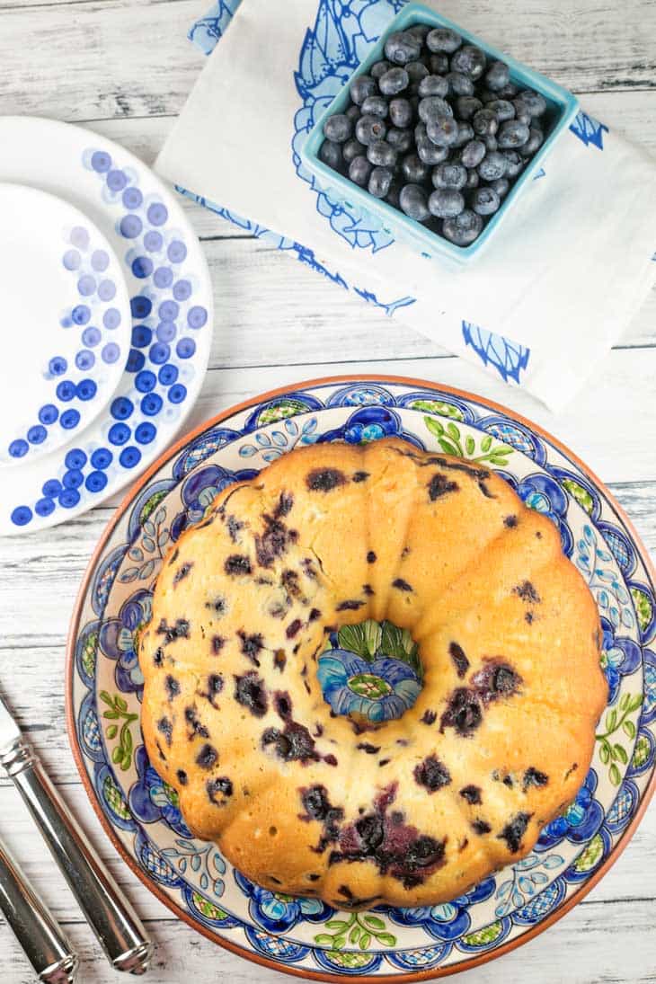 overhead view of a bundt cake packed full of fresh blueberries