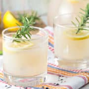 lowball glasses filled with rosemary lavender lemonade and sprigs of rosemary