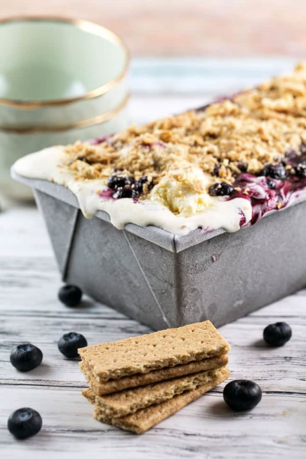 homemade blueberry pie ice cream topped with graham cracker crumbs frozen in a loaf pan