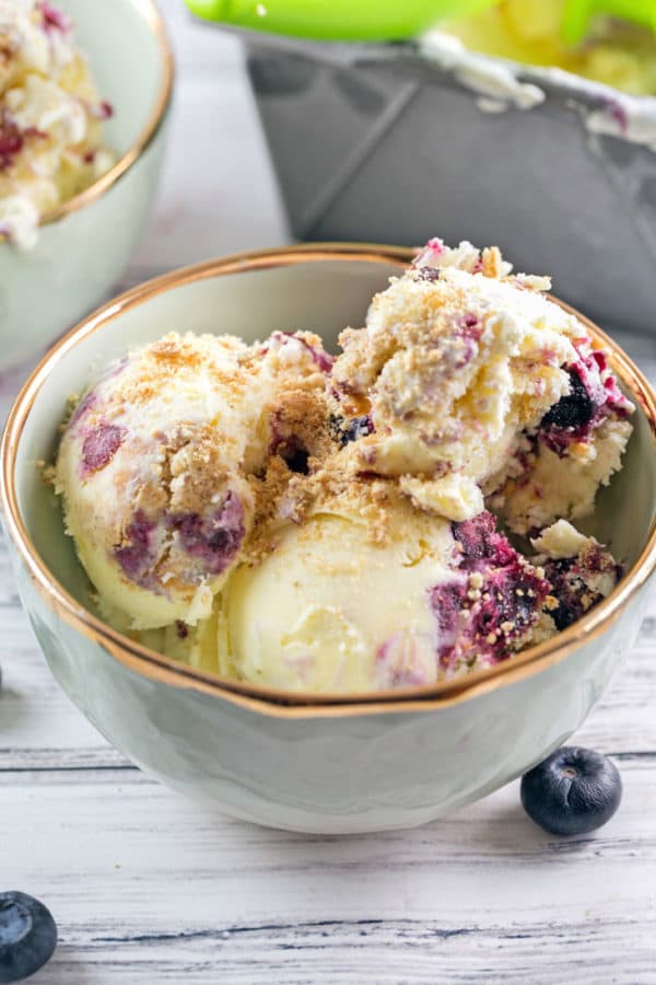 close up view of scoops of homemade blueberry pie ice cream with graham cracker crumbs on top