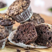 chocolate zucchini muffin cut open to show the dark chocolaty interior