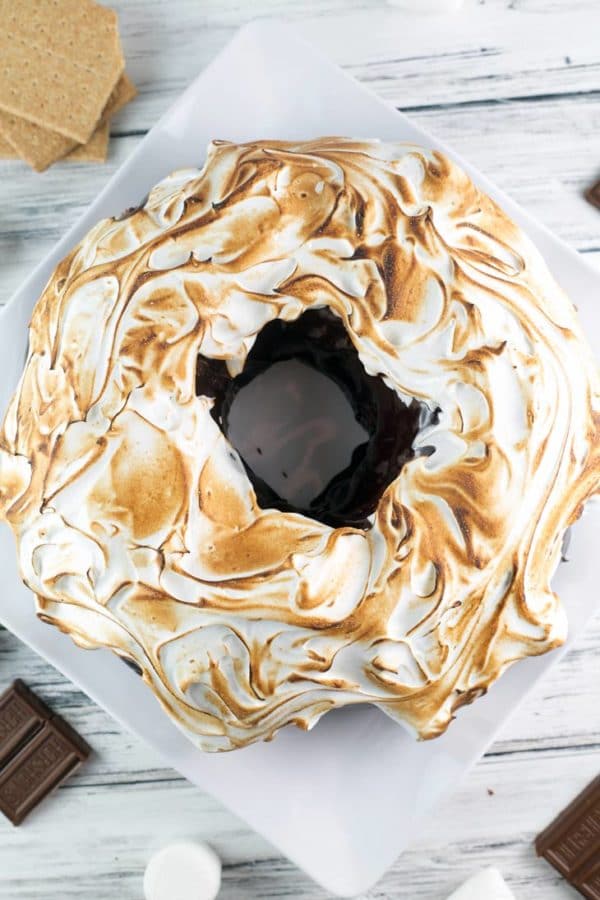 S'mores Bundt Cake: a graham cracker cake with chocolate ganache and homemade marshmallow fluff frosting toasted to a perfect brown. It's just like your childhood favorite - but even better! {Bunsen Burner Bakery}
